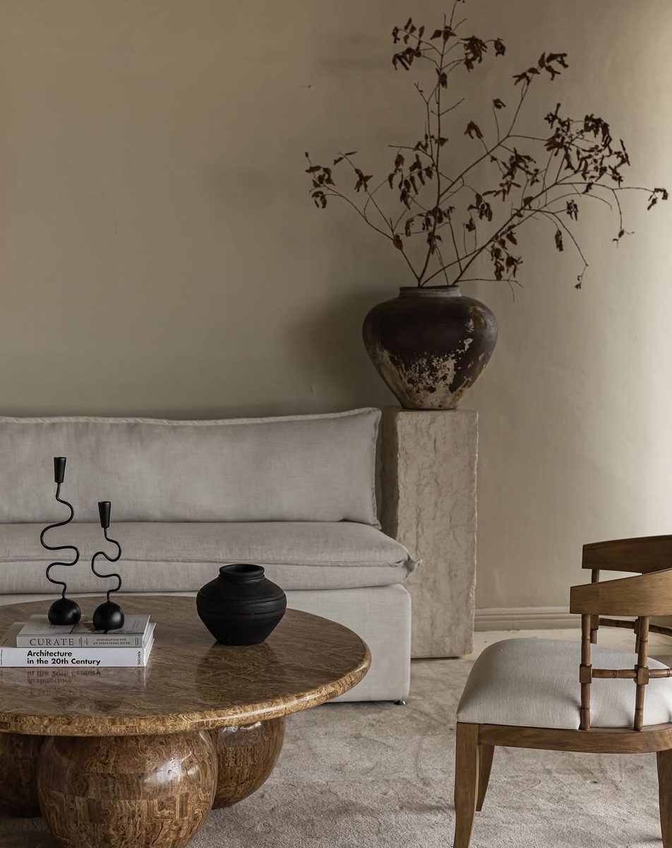 Plaster living room with a round timber table