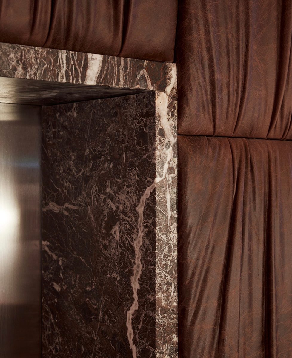 Rosso marble and rust-toned drapery detail