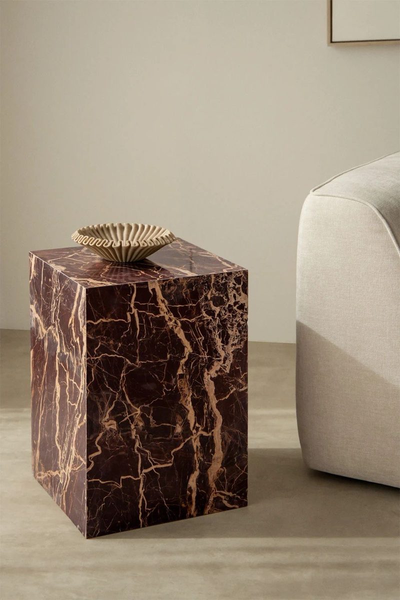 Rosso marble side table beside boucle seating
