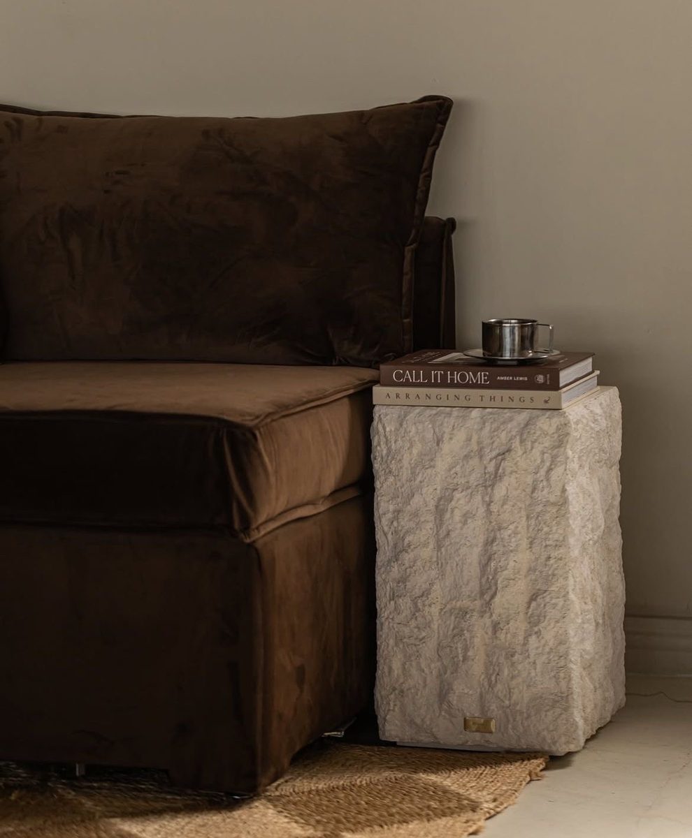 Suede seating beside a stone plinth